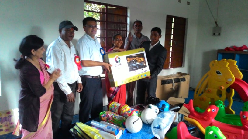 Handing over the school materials.